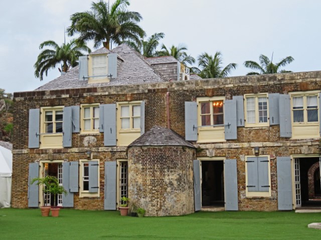 Blick auf Kolonialhaus aus Stein mit grauen Fensterläden am Nelson’s Dockyard, Antigua