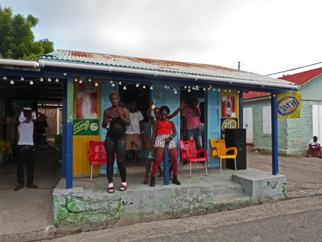 Junge Leute tanzen vor einem Kiosk auf Antigua