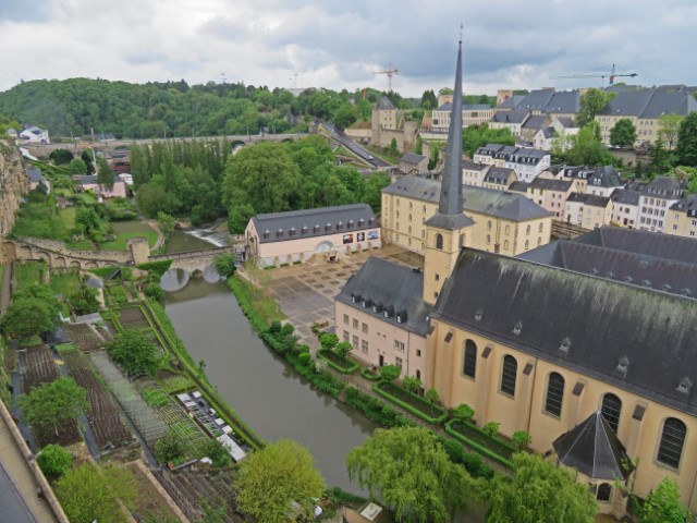 Blick von oben über Luxemburg City mit einer gelben Kirche und einem Wassergraben