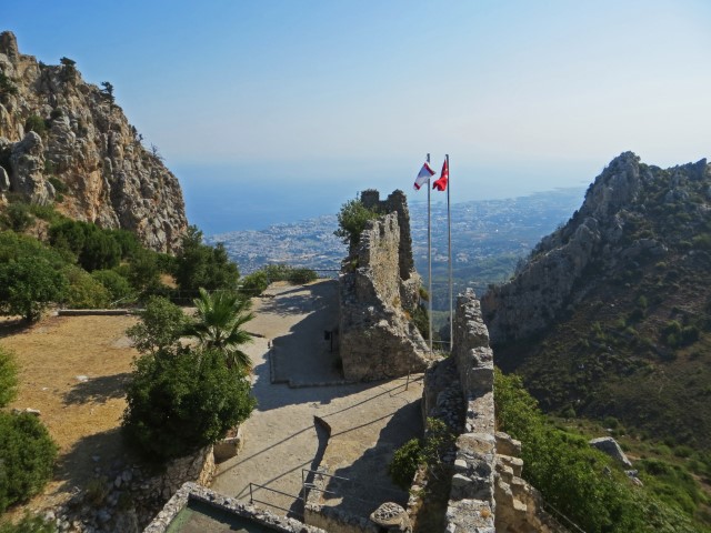 Ruine St. Hilarion mit Flaggen und Blick über Wälder und das Meer, Nordzypern