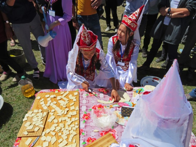 Frauen in weißer Tracht backen Boorsok am Song Köl See