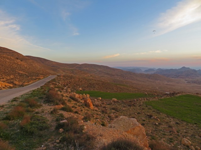 Sonnenuntergang über einer bergpgen, trockenen Landschaft in Jordanien