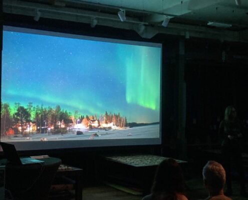 Bernadette Olderdissen beim Travel Slam Hamburg mit Nordlichthimmel auf der Leinwand